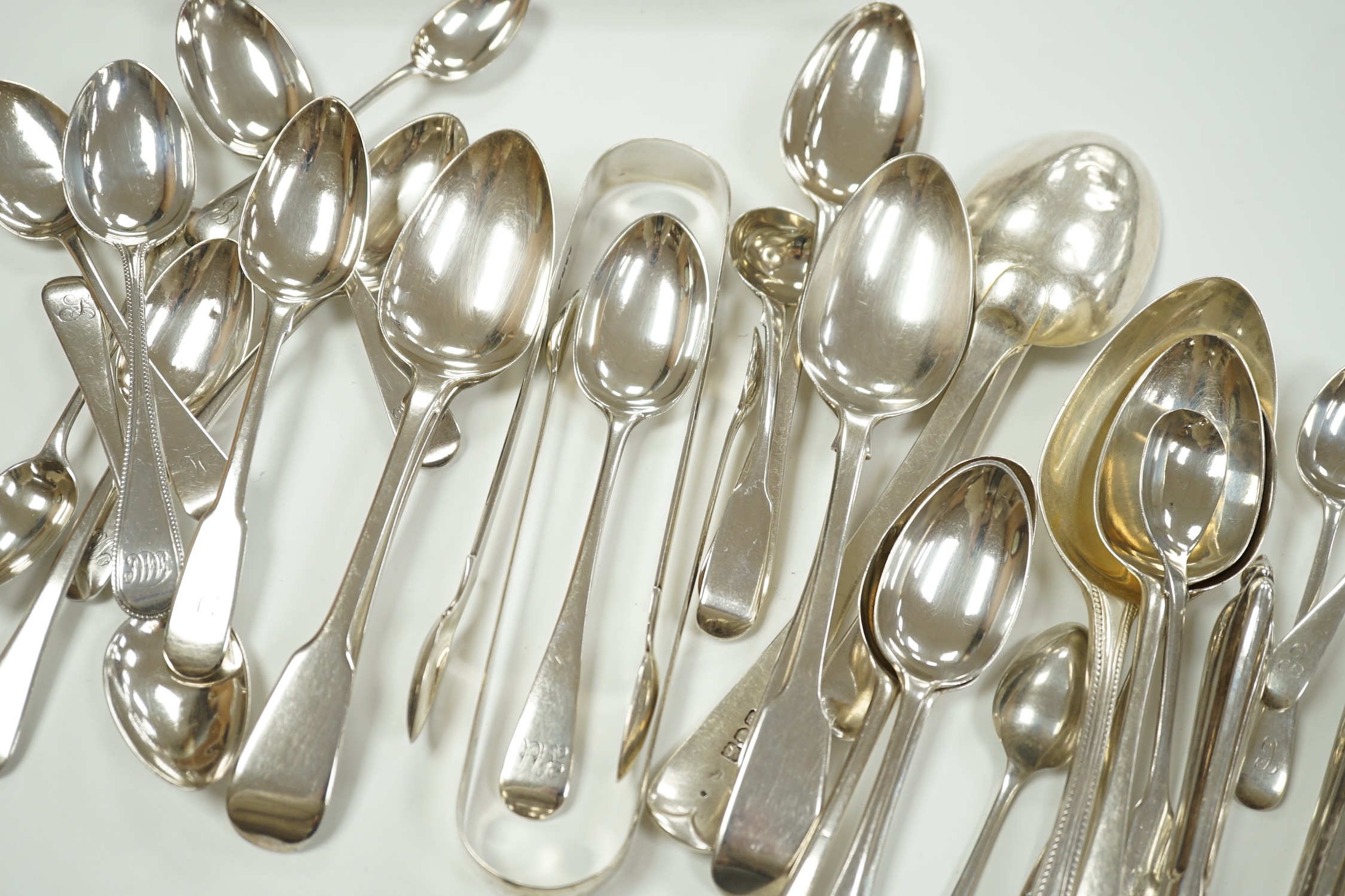 A quantity of assorted mainly 19th century silver flatware, various patterns, dates and makers, including a cased set of six 1937 Coronation silver teaspoons, four pairs of Georgian sugar tongs and a pair of Edwardian si